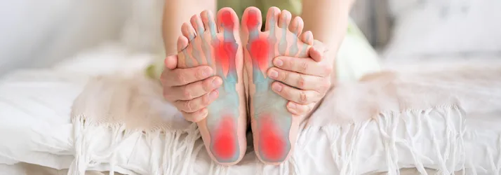 Person holding their feet.