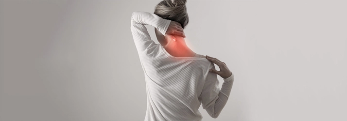 Chiropractic Toronto ON Neck Pain Patient holding their neck in pain.