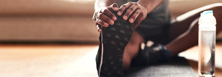 Person stretching on a yoga mat.
